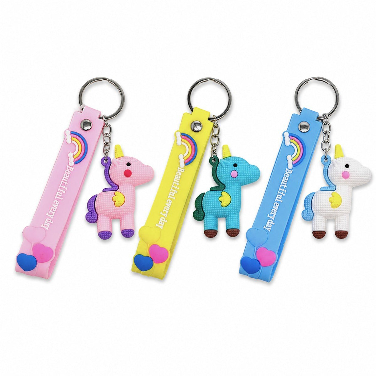 Tre portachiavi con unicorno kawaii in rosa, giallo e blu con strap decorato e arcobaleno