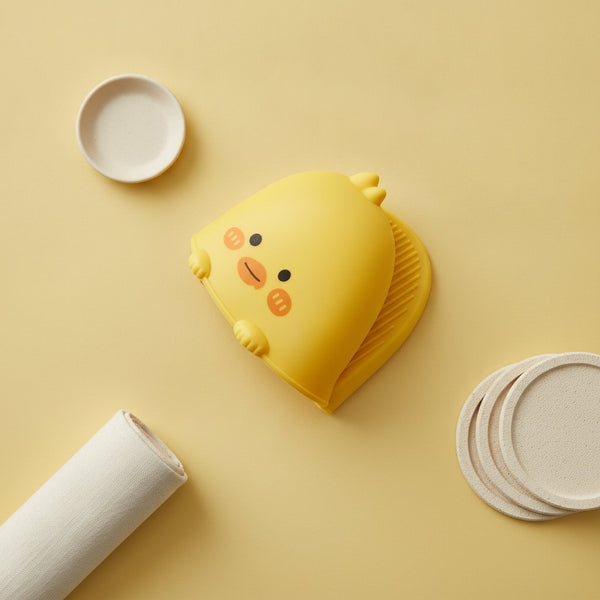 Presina in silicone giallo a forma di pulcino con faccina tenera e dettagli arancioni