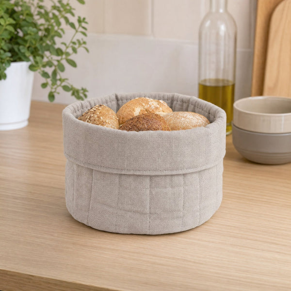 Cestino rotondo in tessuto beige con bordo arrotolato, disponibile in quattro varianti di colore