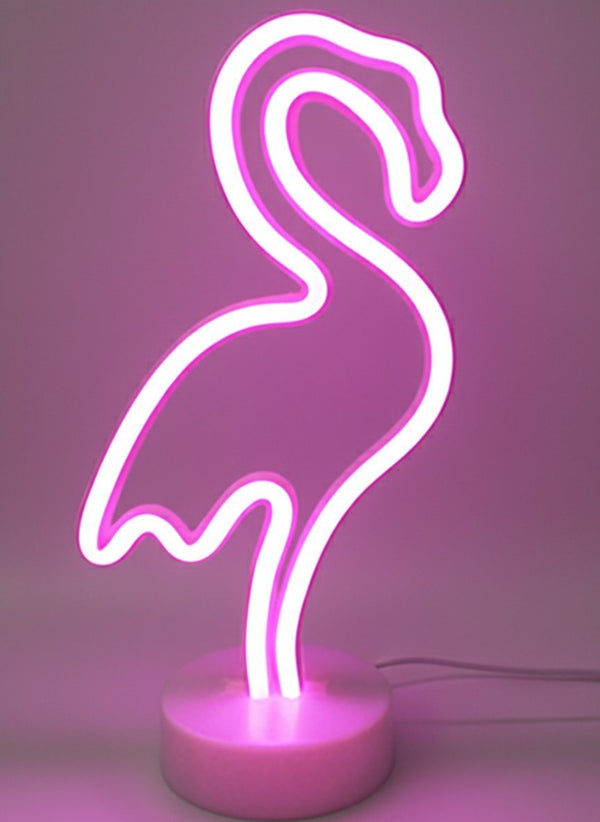 Lampada neon flamingo rosa e bianca su base circolare, design moderno e luminoso su sfondo viola